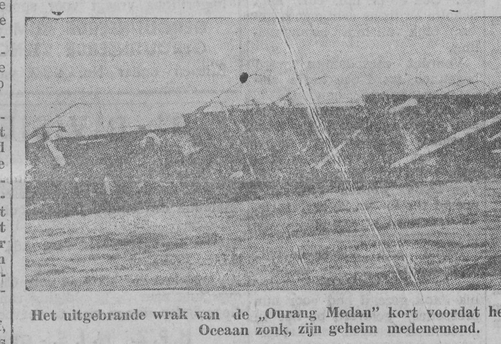 Newspaper photograph of a ship lying on its side at sea, captioned as the burnt-out wreck of the Ourang Medan.